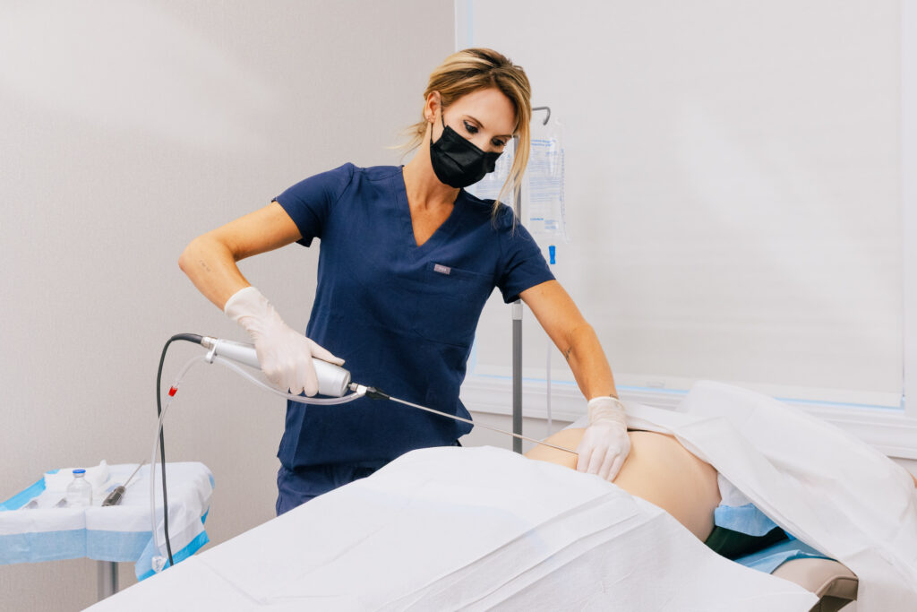 A provider wearing a face mask performs tumescent liposuction near Granger, IN