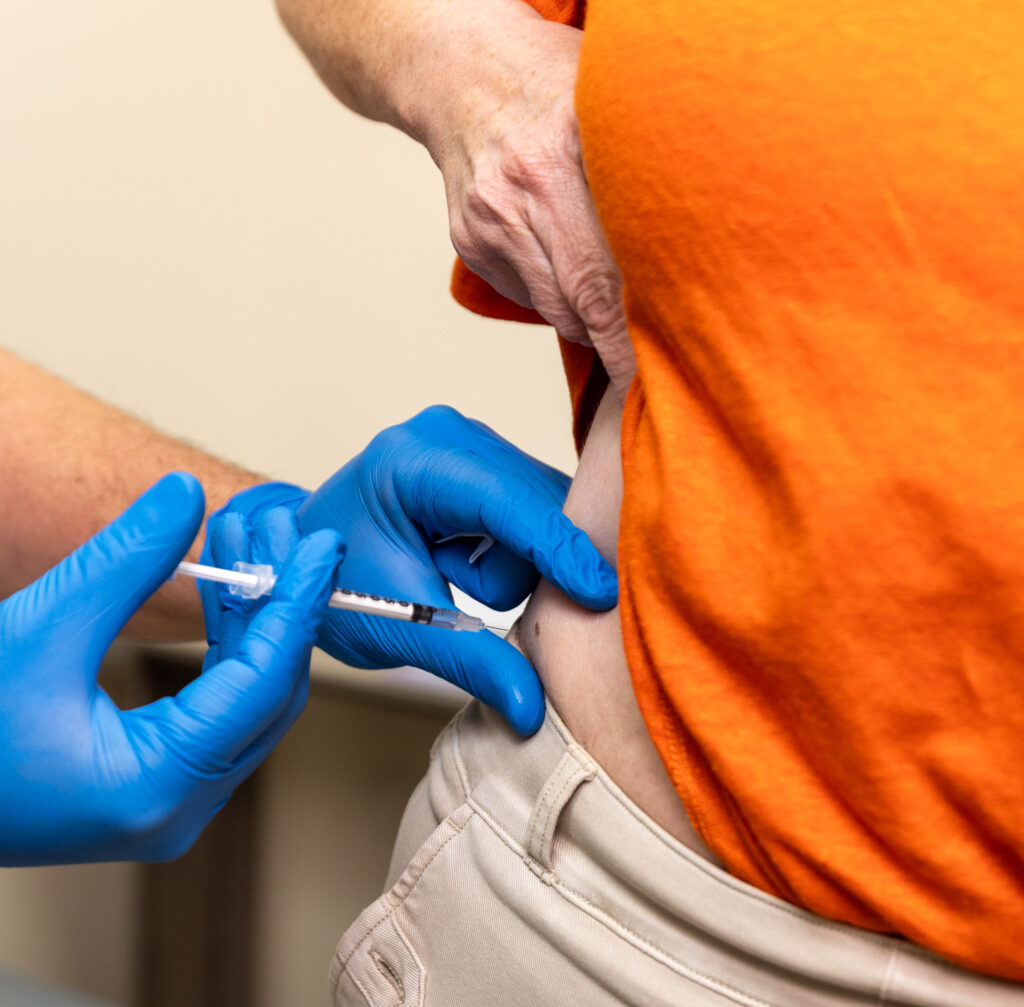 A gloved provider administers GLP-1 treatments in Mishawaka, IN