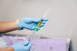 A gloved regenerative medicine doctor in Mishawaka readies a PRP injection