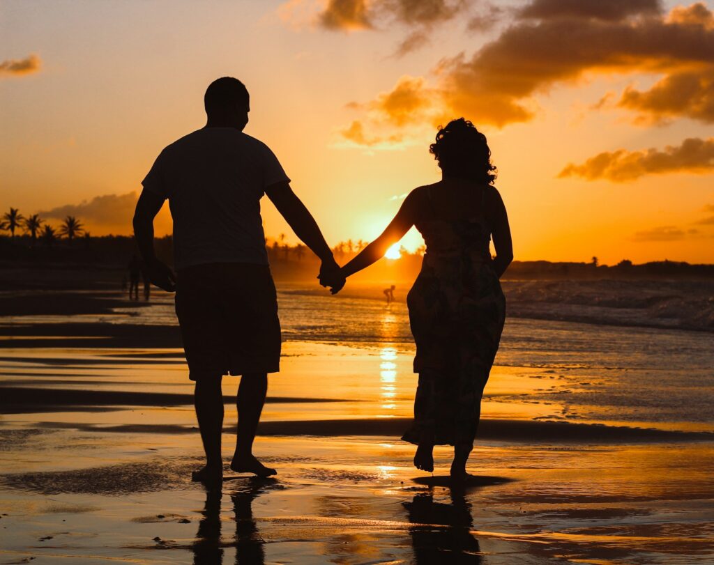 A couple walks on the beach after an arthritis treatment in Mishawaka